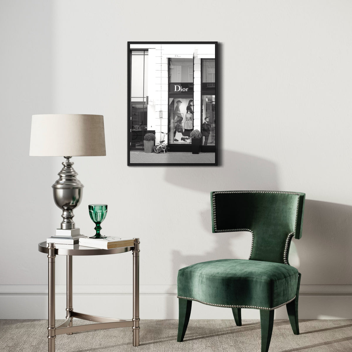 Modern living room with green velvet chair, side table, and black and white art poster on wall