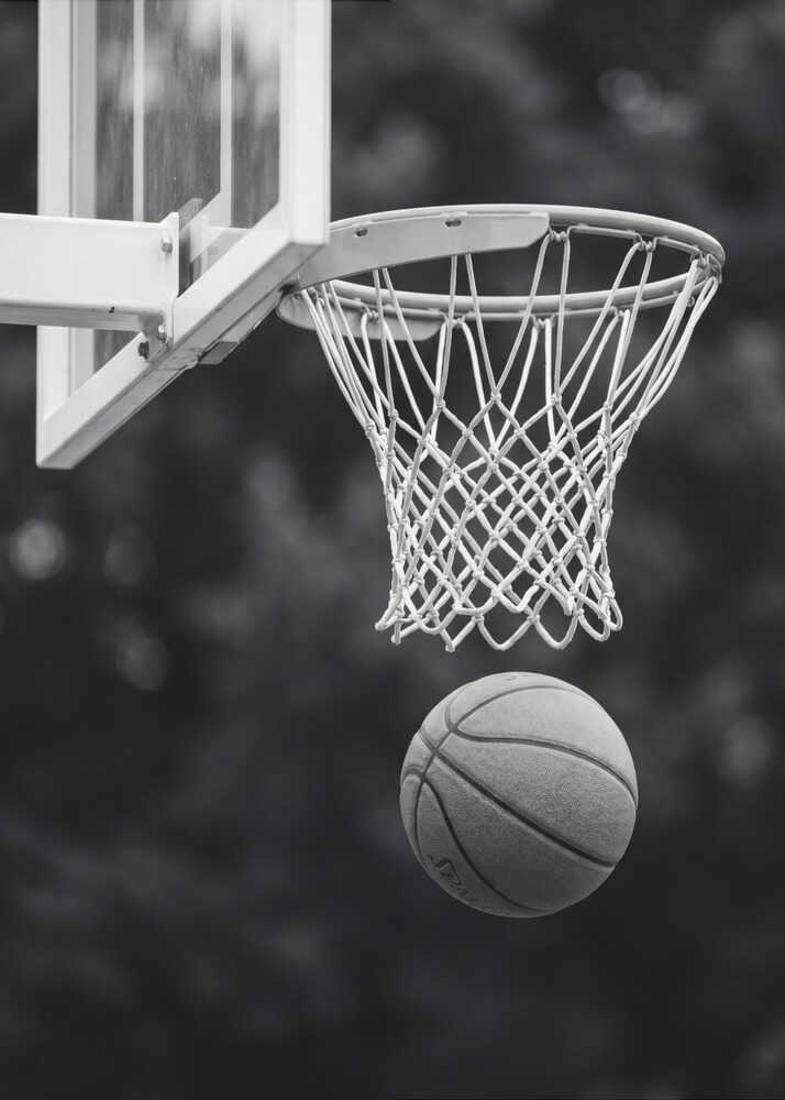 Basketball hoop poster with a black and white view of a basketball hoop and ball in the air