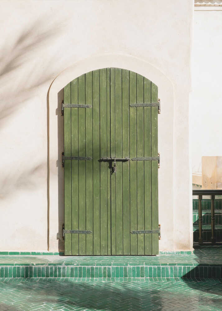 Green arched door poster with a green arched wooden door in a white wall on green tiles