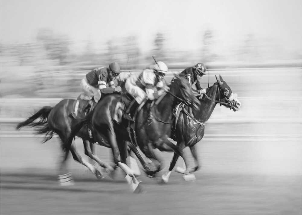Horse racing poster with a black and white view of horses and jockeys racing with motion blur