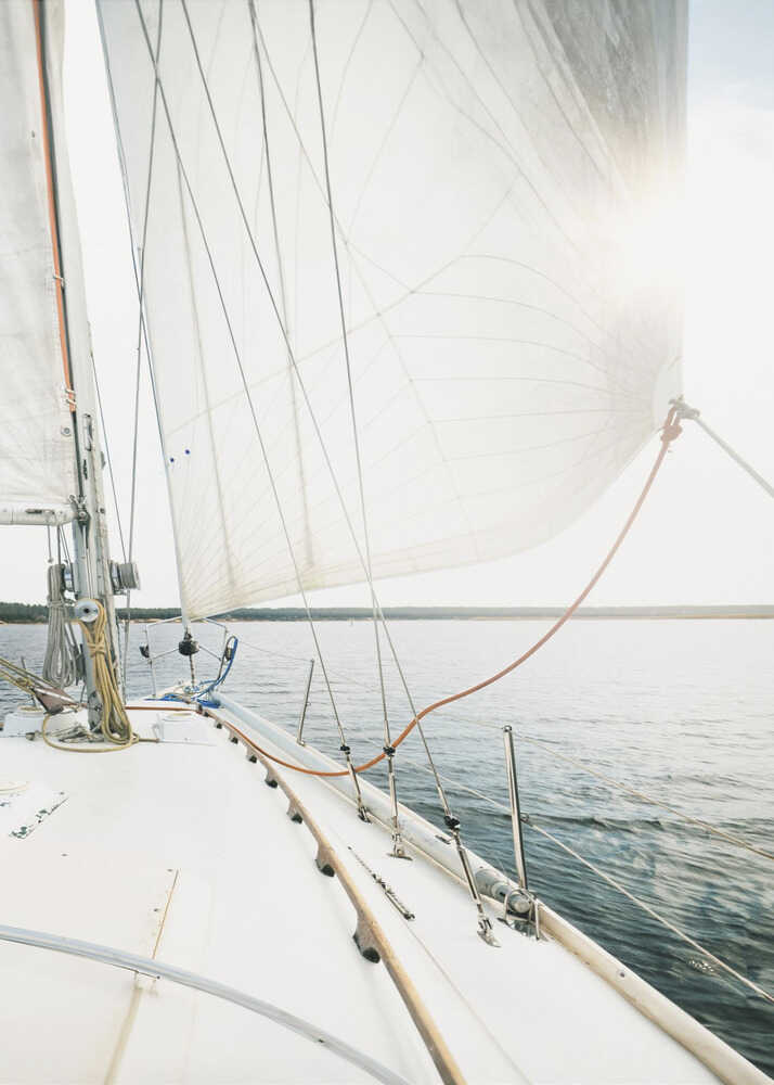 Sailboat deck poster with a view from a sailboat deck of white sails and the water