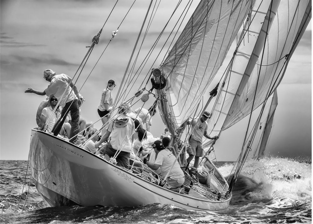 Sailing boat poster with a black and white view of a sailboat heeling with people on deck