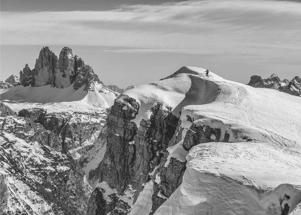 Snowy mountains figure poster with a black and white view of snowy mountain peaks and a figure on a ridge