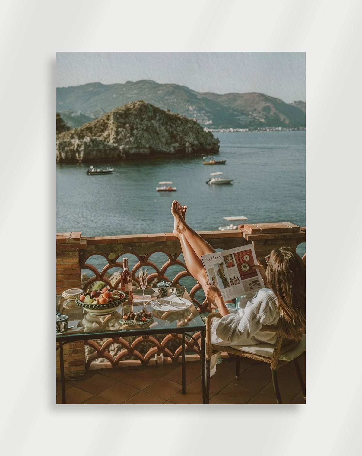Woman balcony sea poster with a woman reading a magazine on a balcony overlooking a bay with boats